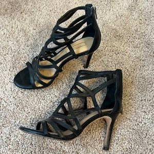 Black leather Antonio Melani heel. Zips up on heel. Size 6.